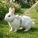 Load image into Gallery viewer, A white bunny standing in a grassy garden wearing a beige neutral-toned rabbit harness and leash set for safe everyday walks.