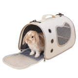 Load image into Gallery viewer, A cream-colored soft-sided rabbit travel carrier with front flap open, showing a Holland Lop bunny sitting comfortably inside with mesh ventilation windows.