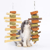 Load image into Gallery viewer, Holland lop bunny chewing on hanging apple wood and timothy hay cake toy string in cage