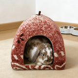 Load image into Gallery viewer, Small lop-eared rabbit relaxing inside an earthy patterned plush cave bed next to food and water bowls.