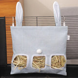 Load image into Gallery viewer, A medium-sized serene blue hanging grass pellet feeder bag with three feeding windows, filled with grass pellets and securely mounted to a wire cage.