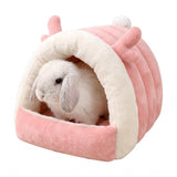 Load image into Gallery viewer, Pink plush bunny cave bed with cute antler details and white fleece trim, featuring a dwarf rabbit resting inside on a clean white background.