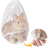 Load image into Gallery viewer, Small bunny safely secured inside a white mesh grooming pouch with claws poking through for precise nail clipping.