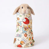 Load image into Gallery viewer, Cute domestic rabbit snugly wrapped inside a cartoon pattern calming grooming wrap burrito swaddle to prevent kicking
