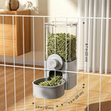 Load image into Gallery viewer, Slate grey hanging rabbit pellet feeder mounted outside an indoor bunny cage, displaying precise dimension callouts of 8.7 inches by 7.9 inches.