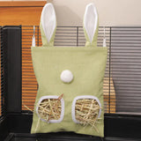 Load image into Gallery viewer, A small mint green cage-mounted grass pellet feeder bag featuring cute rabbit ears and two feeding windows filled with fresh grass pellets.