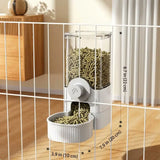 Load image into Gallery viewer, White automatic gravity rabbit feeder attached to playpen bars, featuring measurements of 8.7 inches high by 7.9 inches long and a 3.9-inch wide bowl.