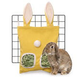 Load image into Gallery viewer, A Holland Lop rabbit eating grass pellets from a small yellow bunny ear hanging cage feeder bag.